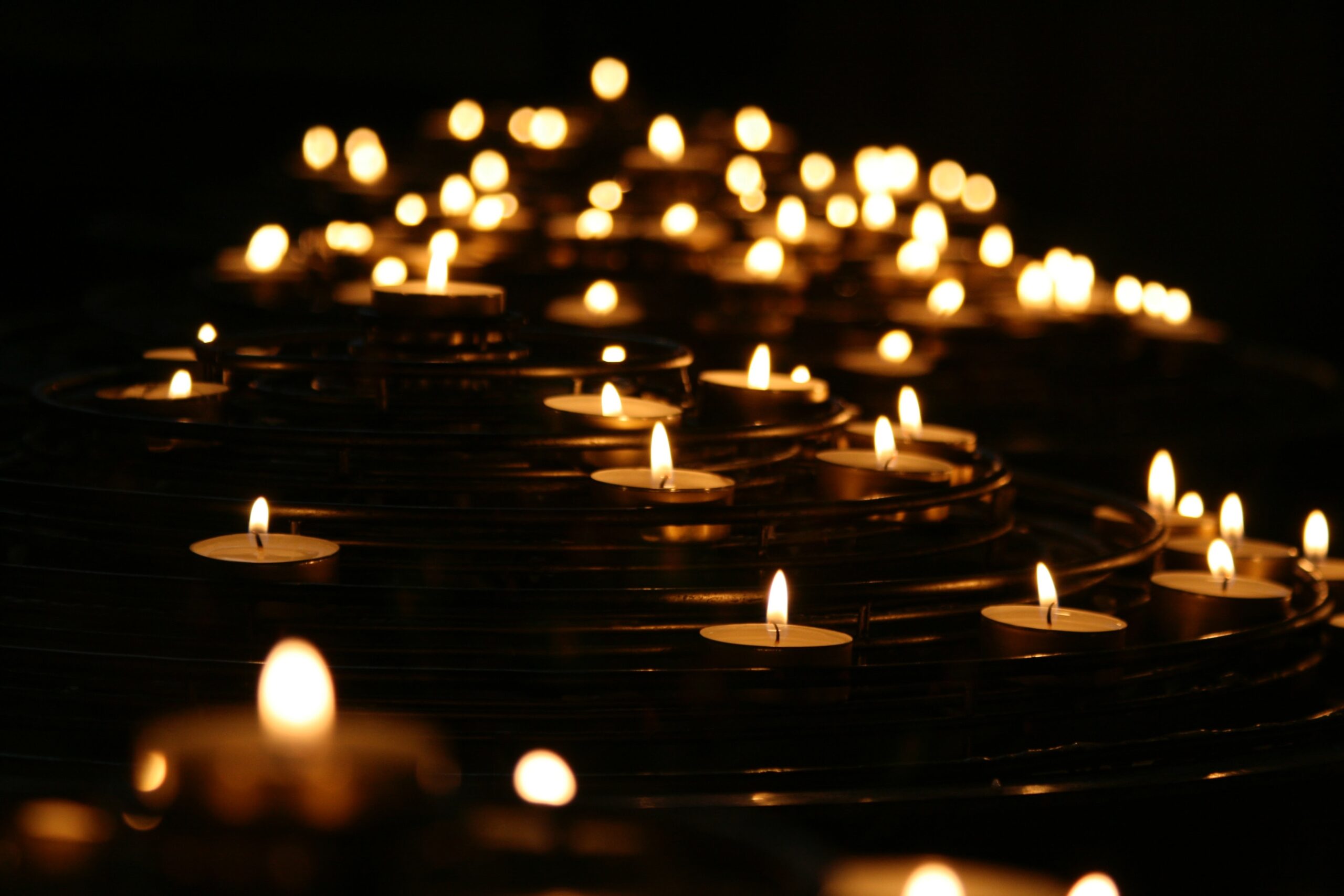 Candles burn in darkness